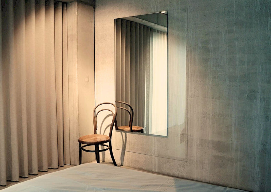 Void XXL mirror by Deknudt Mirrors on a concrete wall